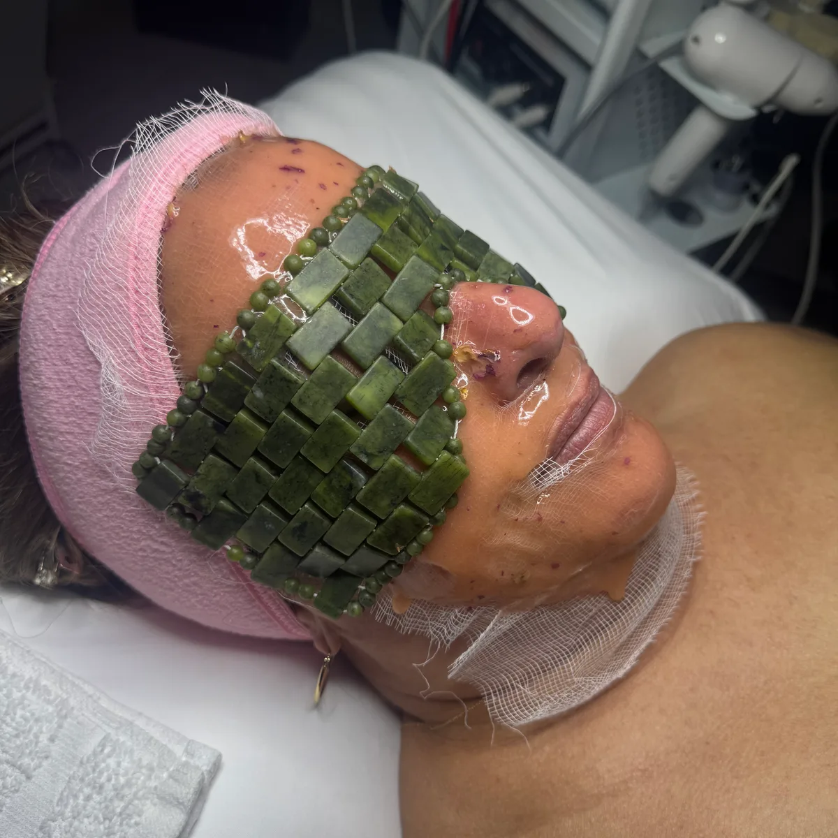 A jade stone mask during a facial